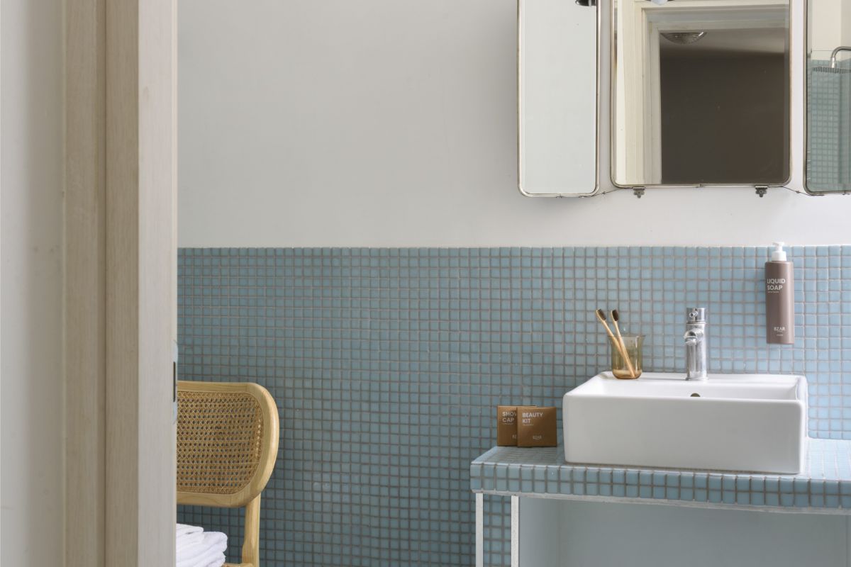 Bathroom with bathtub in Rome Monti district with blue tiles, modern sink and natural light from window - Salotto Monti, BZAR hotels in Rome