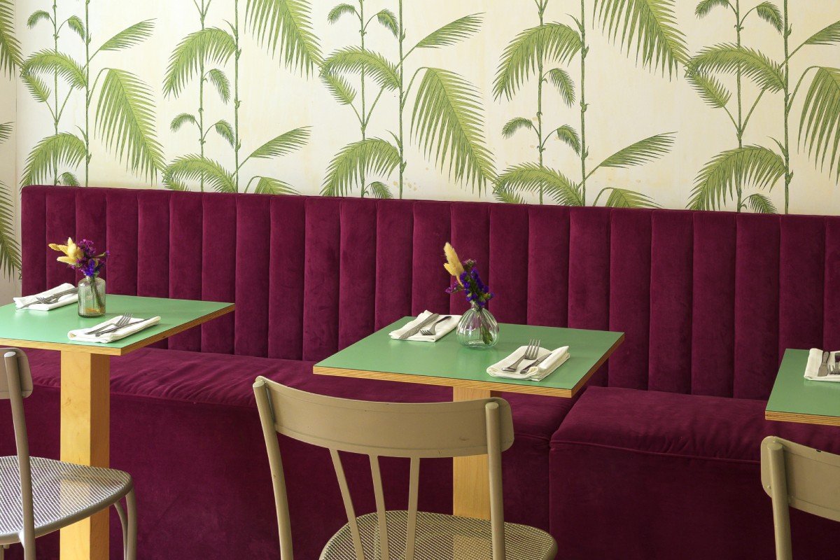 Breakfast room detail in Rome Monti district with green tables, velvet seating and elegant table setting - Salotto Monti, BZAR hotels in Rome