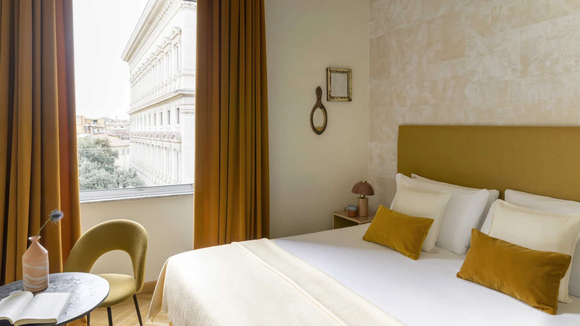 Superior room in Rome Monti area with blue feature wall, bed with yellow cushions, decorative details and wooden floor - Salotto Monti, BZAR hotels in Rome