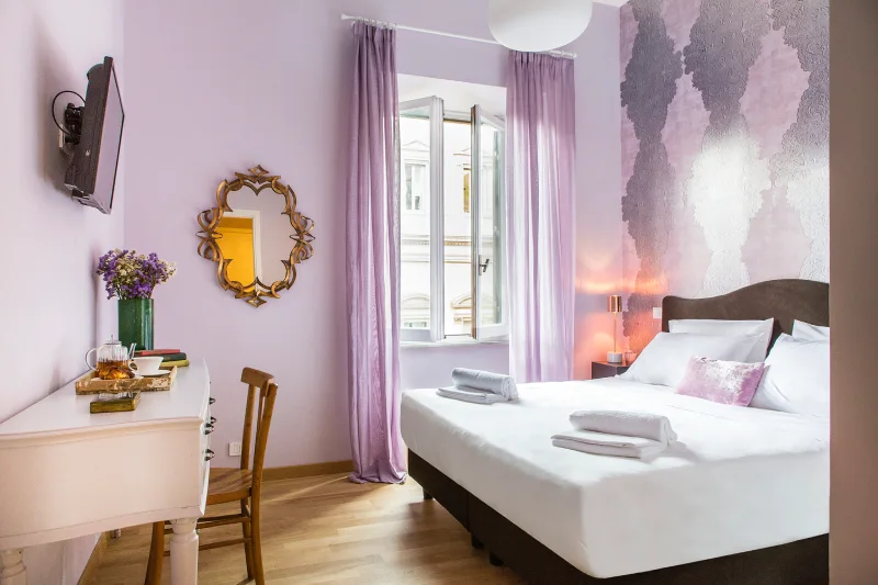 Romantic room in Rome Monti district with lilac walls, double bed, open window, sheer curtains and ornate mirror - Salotto Monti, BZAR hotels in Rome
