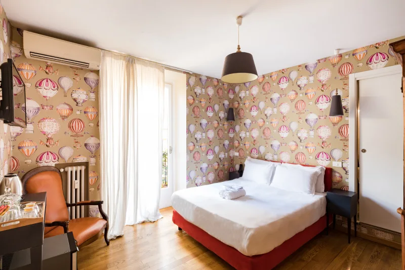 Creative design room in Rome Monti district with hot-air balloon wallpaper, double bed and natural light from French doors - Salotto Monti, BZAR hotels in Rome